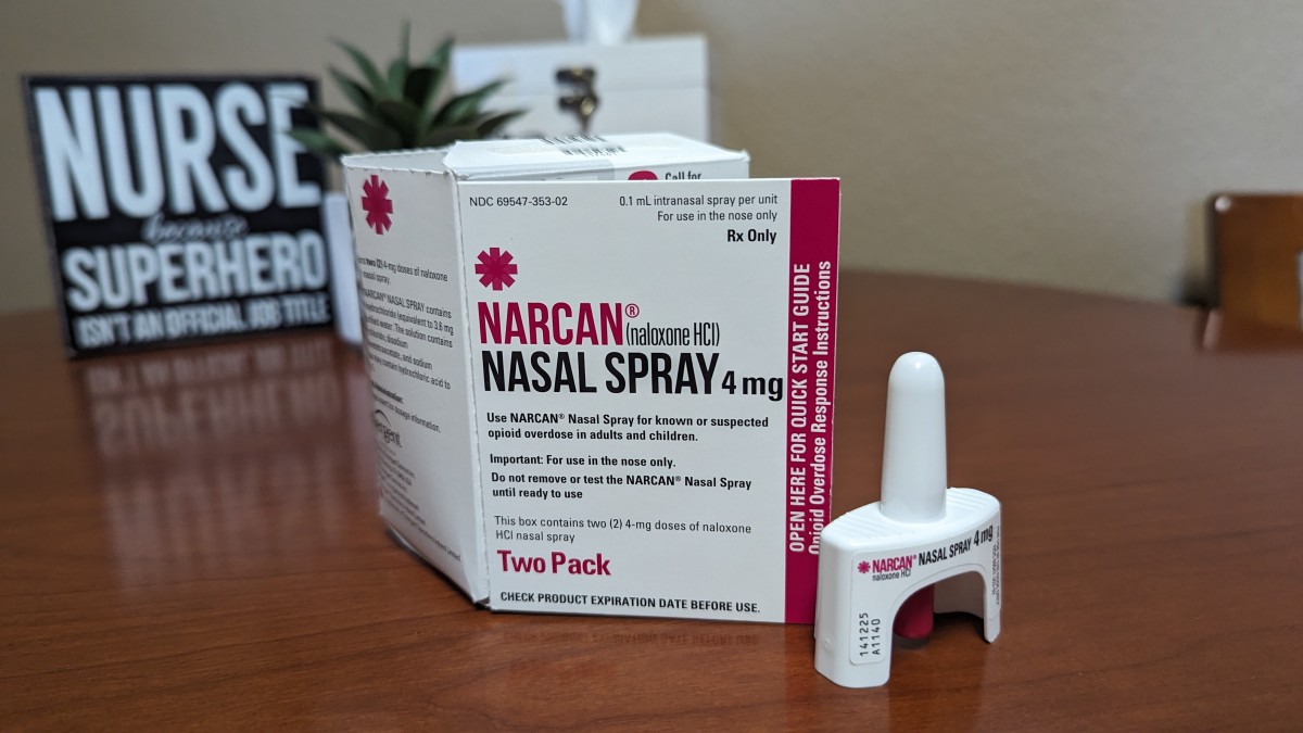 a hand holding a narcan nasal spray